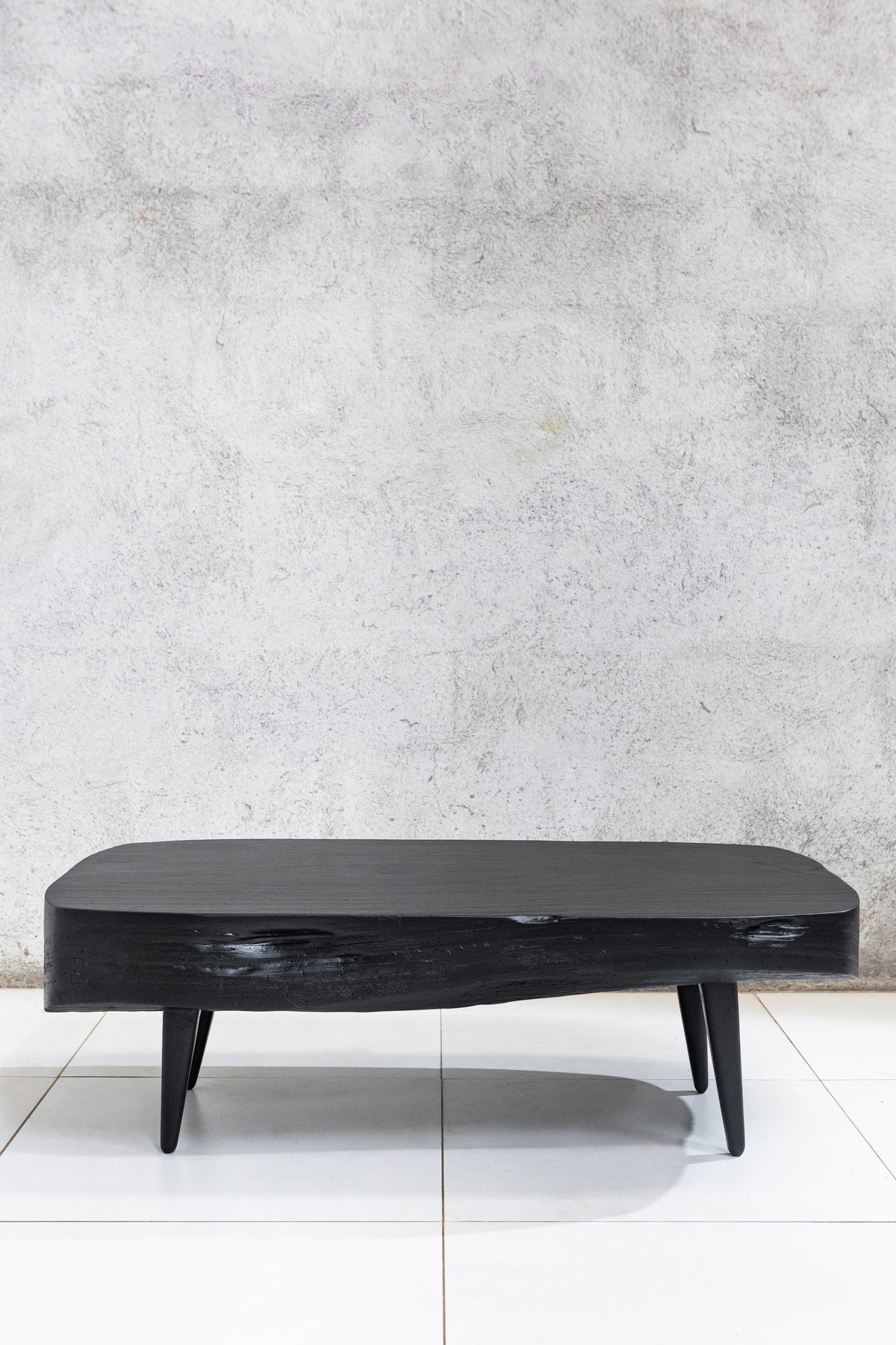 Sabana Brasa Guanacaste coffee table seen straight on, torched black with a charred live edge