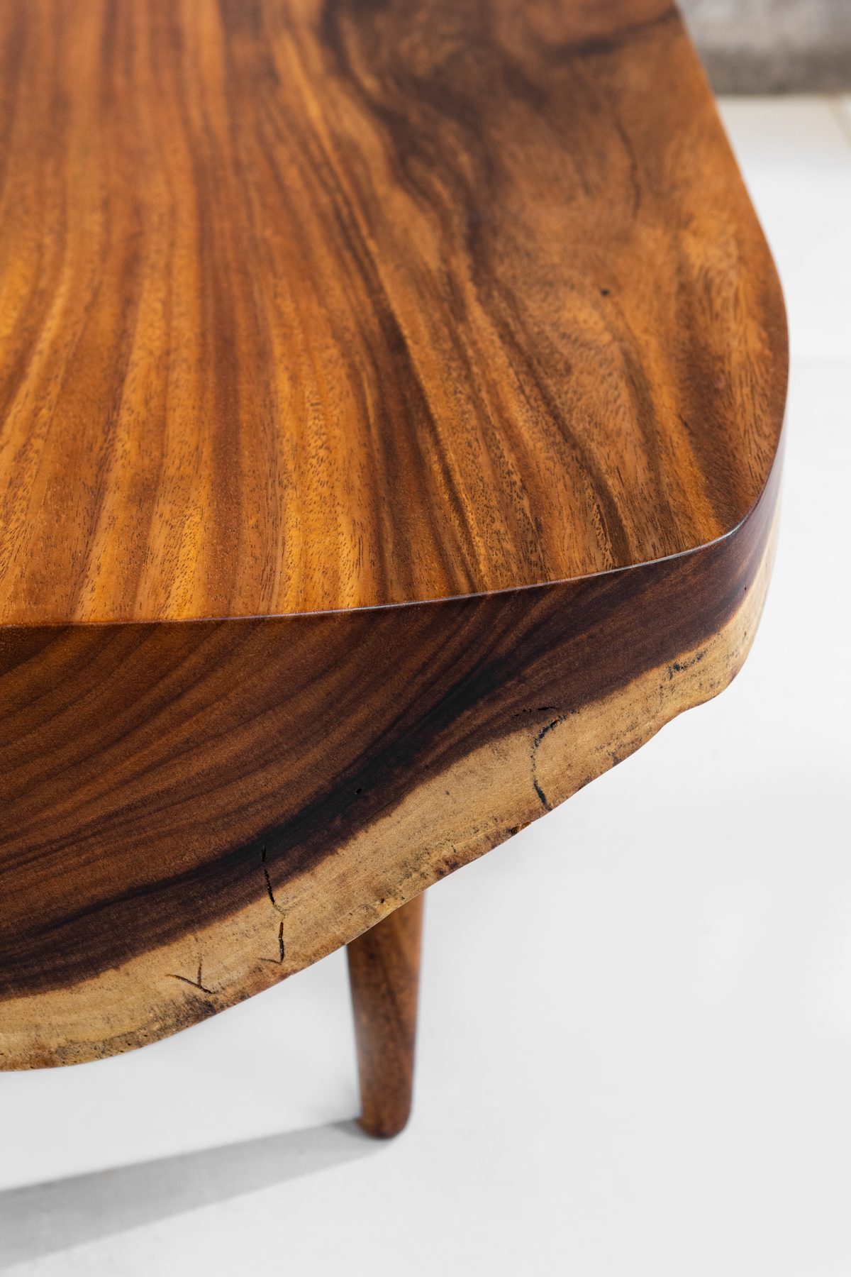 Detail of the Sabana II top — dark figured Guanacaste grain meeting the pale live edge
