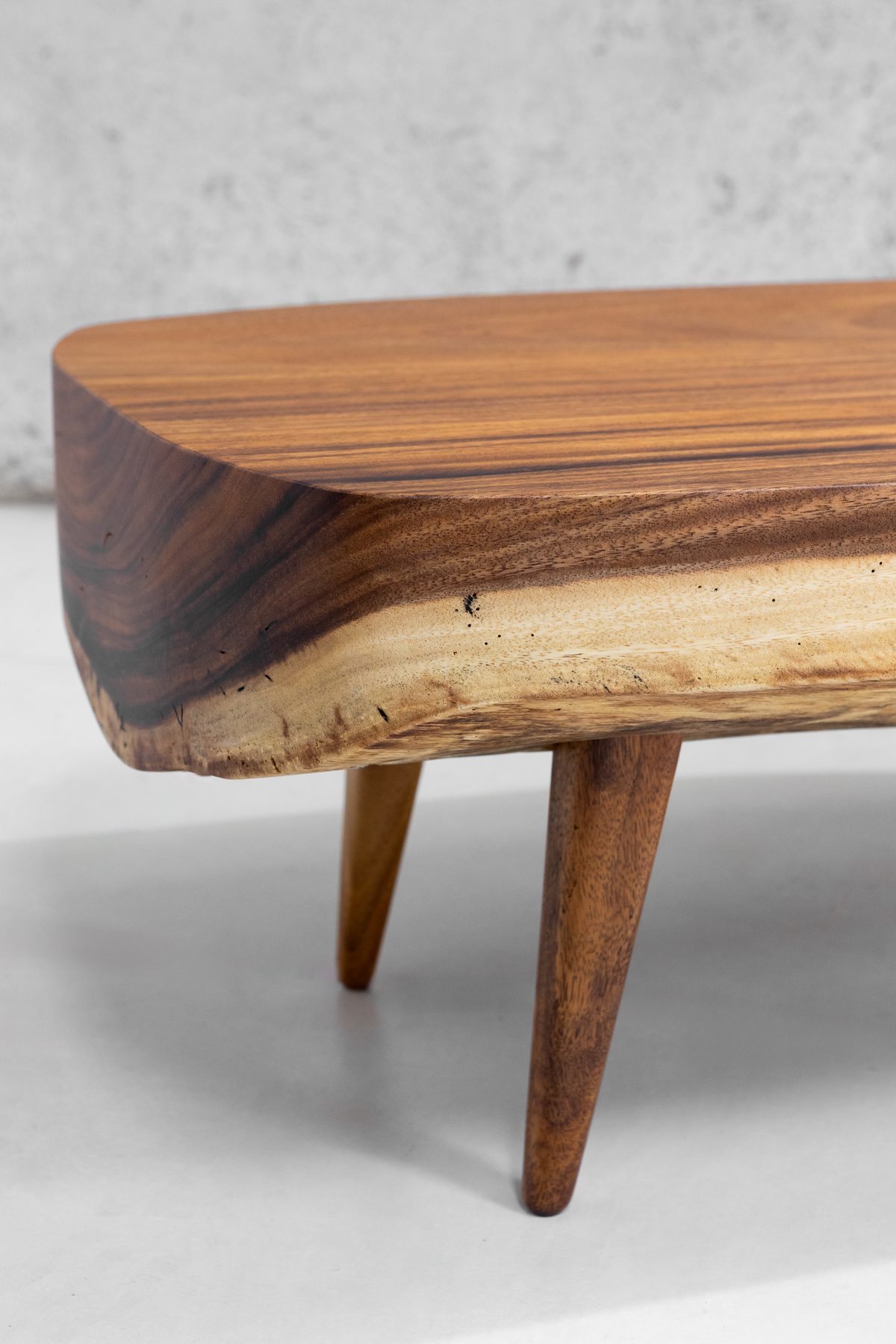 Detail of the Sabana III top — pale honey Guanacaste grain and the sapwood edge