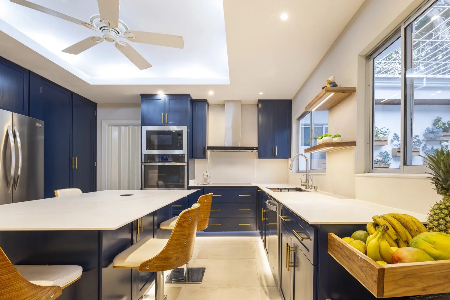 Custom navy hardwood kitchen with brass hardware in Escazú by Bernardo Urbina