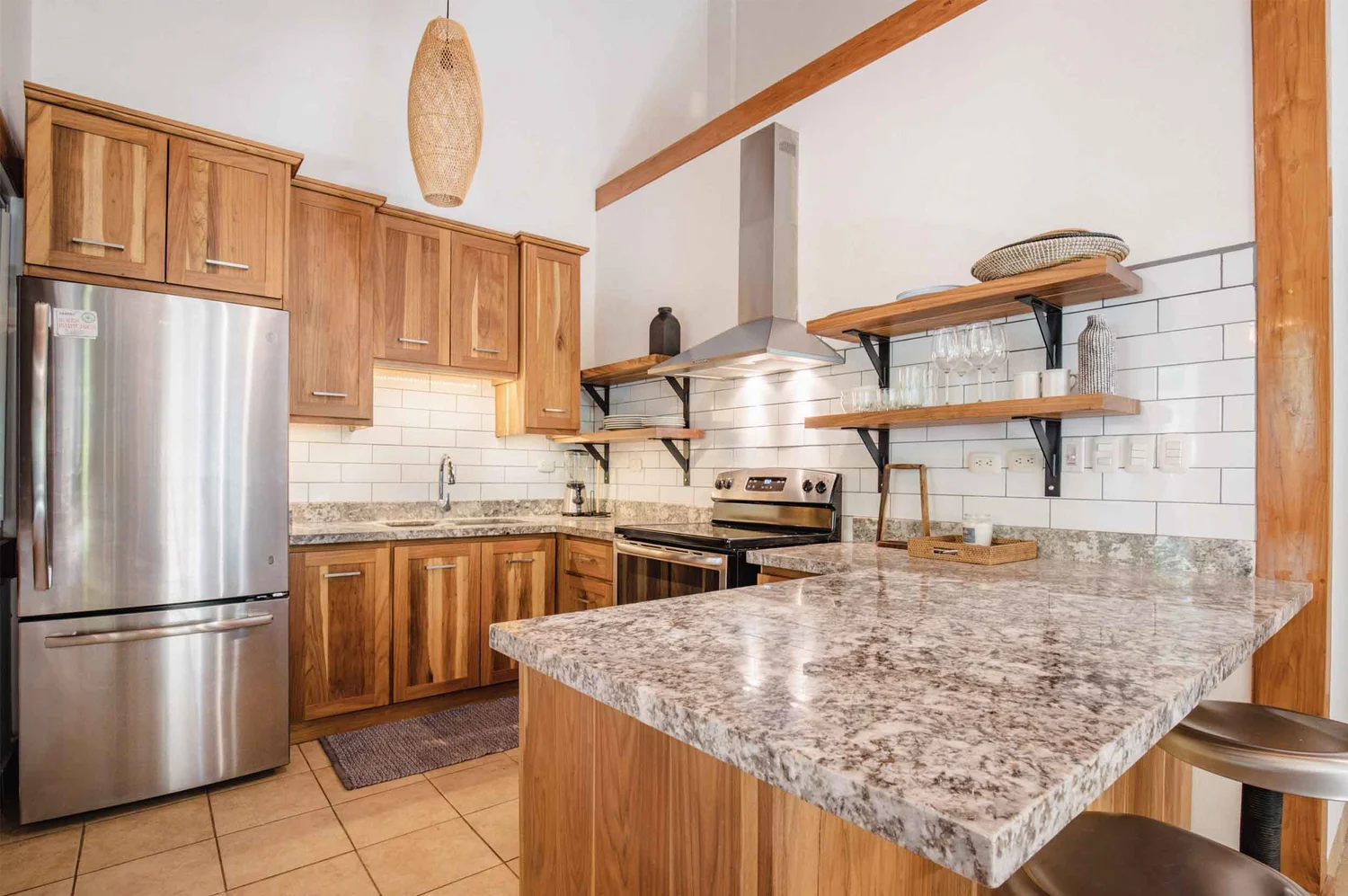 Custom laurel wood kitchen with open shelving in Nosara by Bernardo Urbina