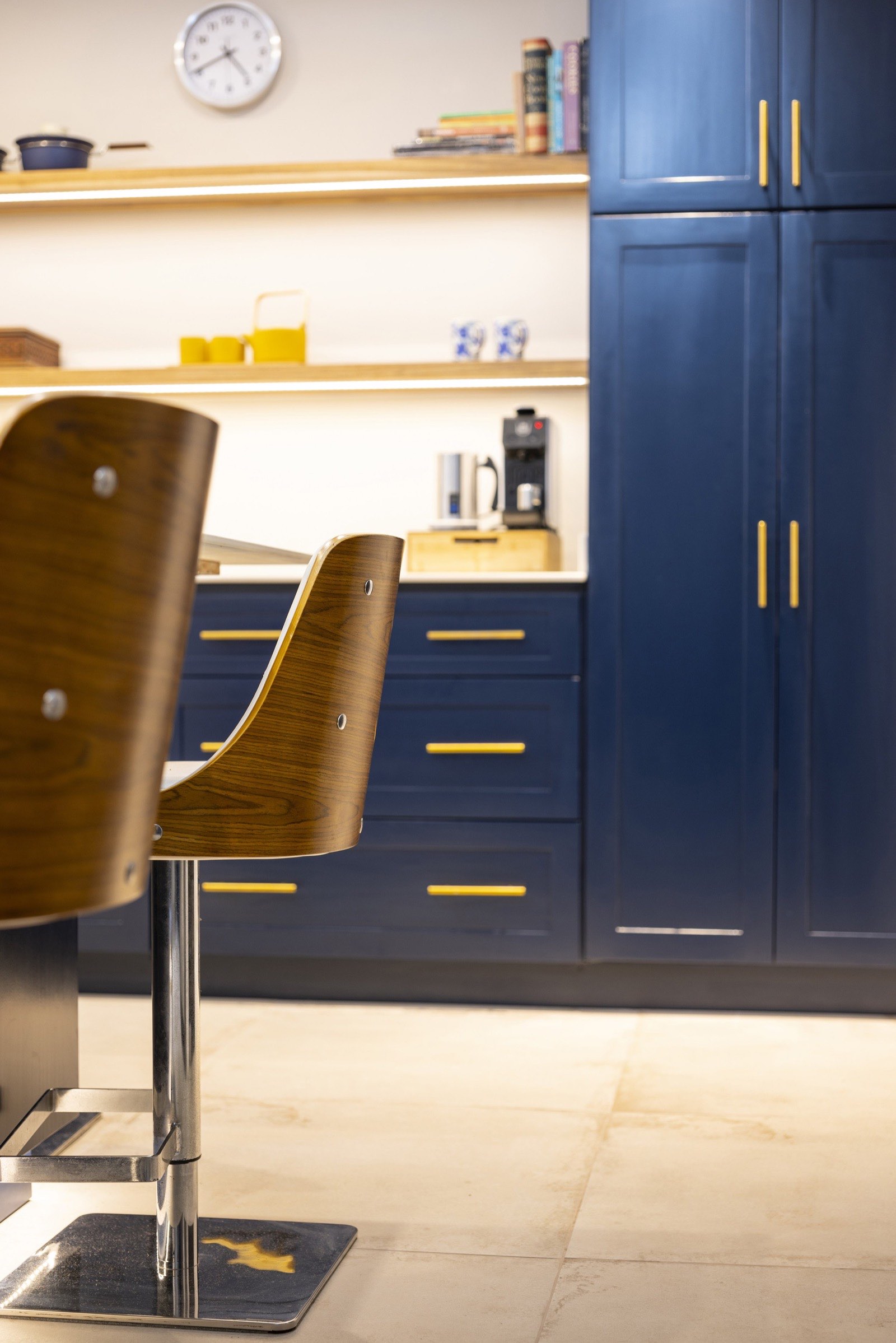 Wood bar stools at the island beside styled Laurel open shelving