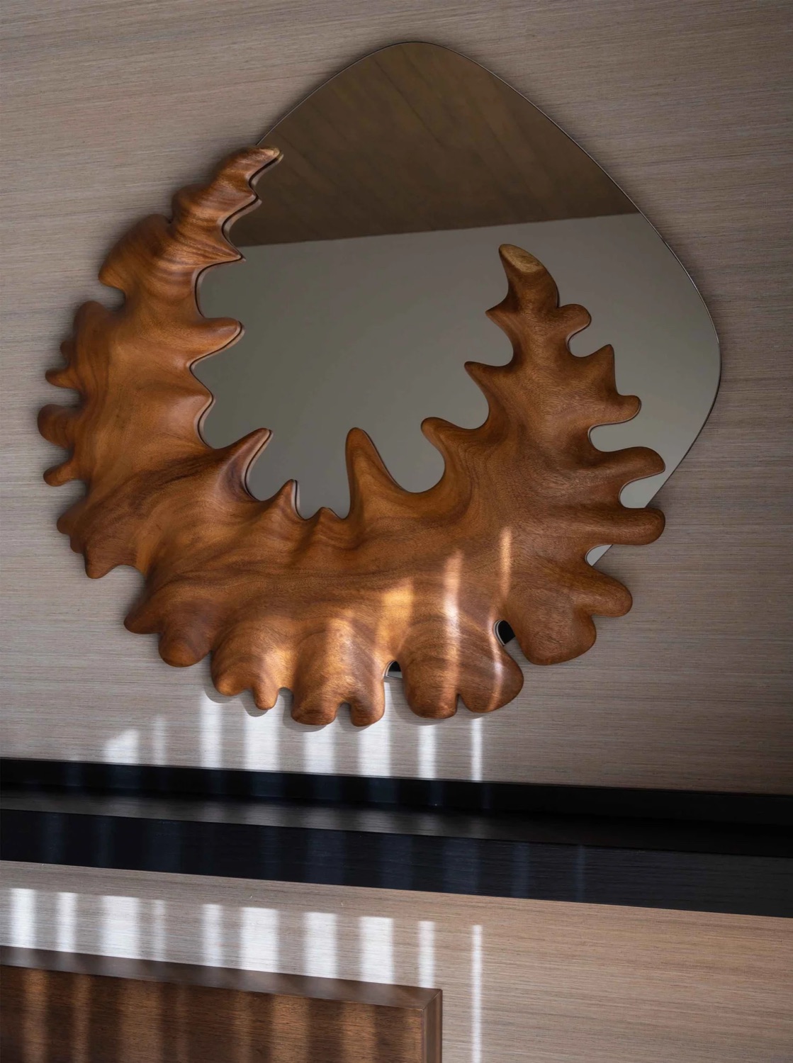 Coral Mirror — sculptural Guanacaste wood wall mirror by Bernardo Urbina, in a residential interior