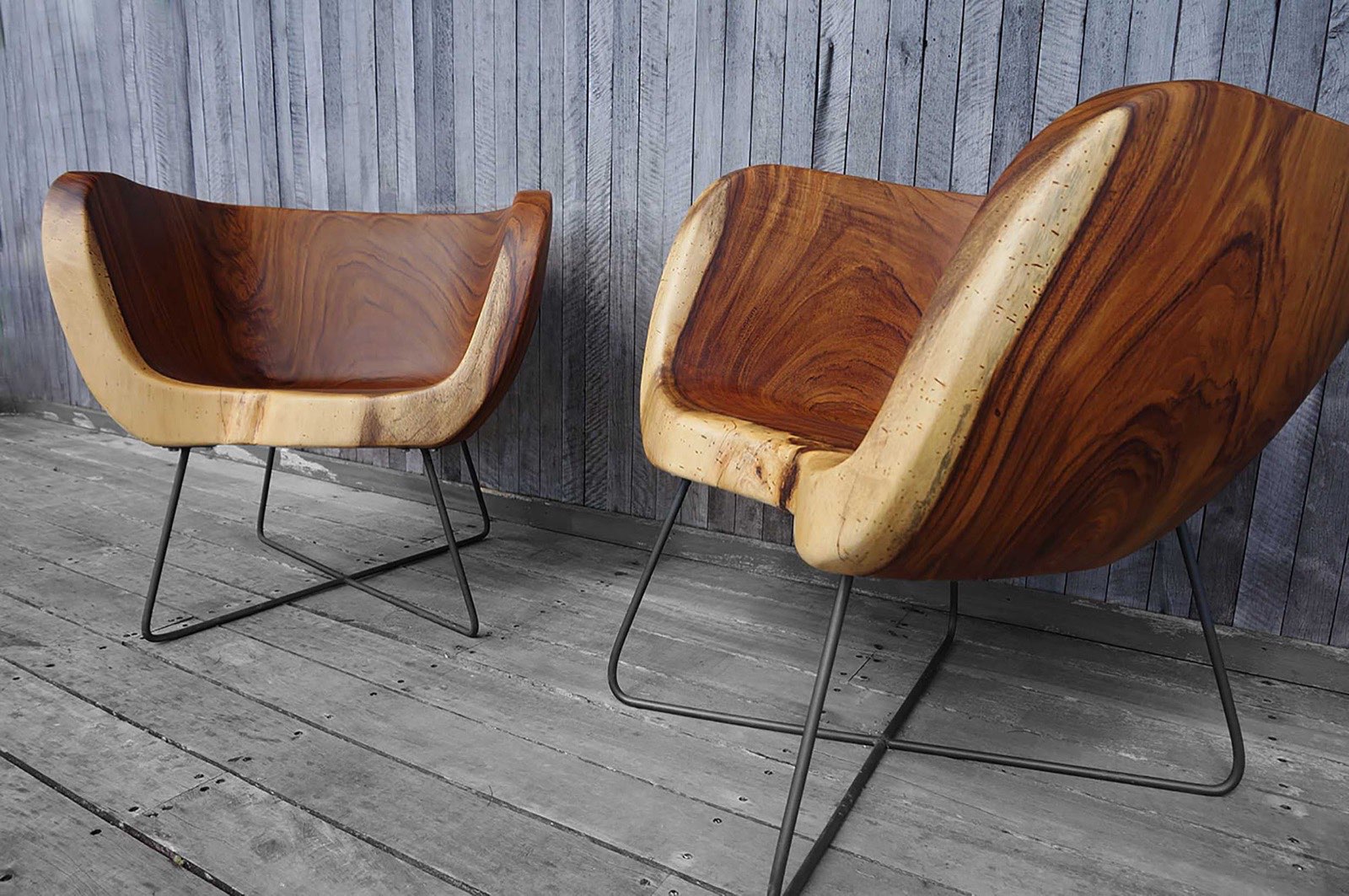 A pair of Pacífico chairs seen from a low angle, showing the sculptural hollowed seats and steel bases