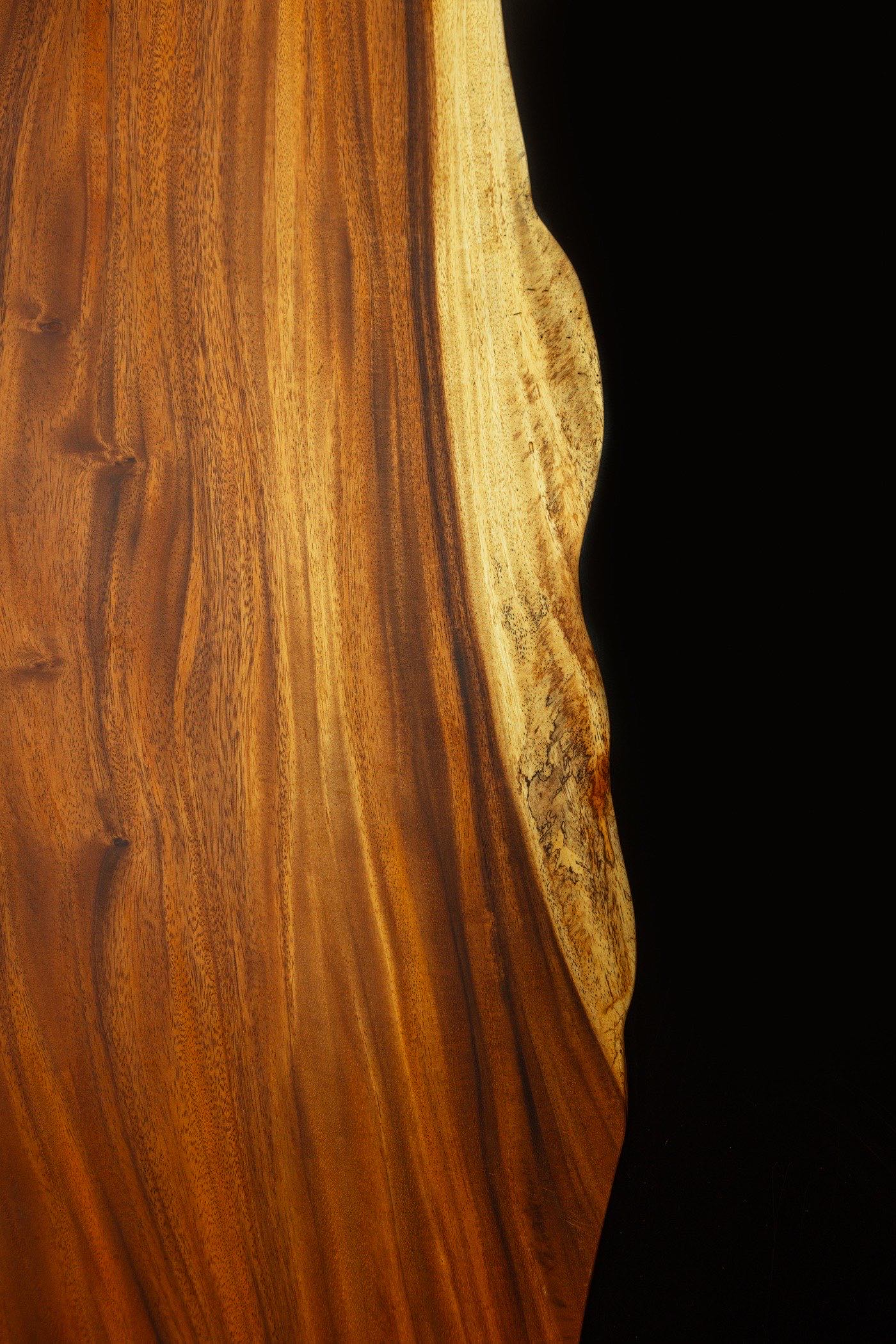 Detail of the Reventazón door — Guanacaste grain and figure across the slab